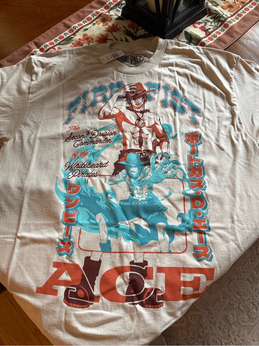 Onepiece Cream Graphic Tee with Teal & Orange Print